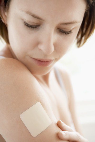 photo of a woman with a nicotine patch on her arm