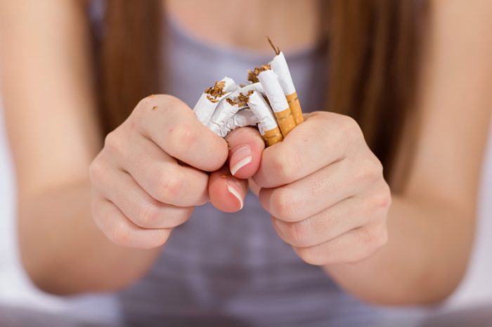 woman breaking cigarettes